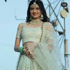 A smiling shot of the client in the mint green meenakari set. This style is lightweight yet impactful, making it a popular rental choice for pre-wedding functions.