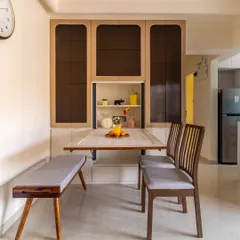 This custom-designed dining unit features a wall-mounted folding table and a sleek bench, providing a complete dining solution that can be neatly tucked away to maximize living space.