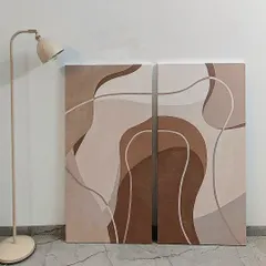 This two-piece canvas set, or diptych, explores form and color in shades of brown and beige. The continuous, flowing lines across both canvases create a unified and calming abstract artwork perfect for a modern home.