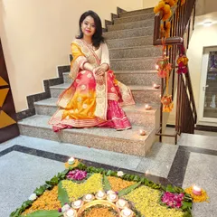 A moment of peace during the festivities. This traditional lehenga, seen here beside a beautiful flower rangoli, is perfect for celebrating cultural moments in style.