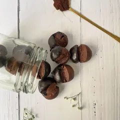Our coffee chocolate cookies spilling from a jar, showcasing one of the delicious items included in our Rakhi gift hampers.