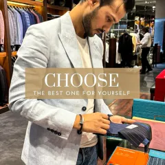 Choice is the first step in couture. A client browses through a selection of pinstripe fabrics for a new suit, an essential part of the collaborative design process in my atelier.
