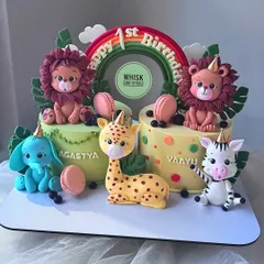 Double the fun with these twin jungle cakes for a first birthday. The set features two separate cakes adorned with cute, matching safari animals.