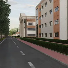 A view down the road alongside the school. This shot emphasizes the scale of the project and how the architectural design fits into its surrounding landscape.