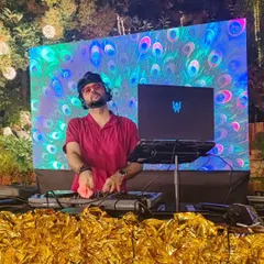The mini wedding season has officially begun. Behind the decks with a vibrant LED backdrop, ready to bring the energy for the happy couple. The golden decor and peacock visuals set the perfect festive mood.