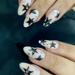 You're a star. This client wanted a Y2K inspired look, so I painted these bold black stars on a neutral base and added some tiny rhinestones for extra sparkle. It's a fun, trendy design for any nail length.