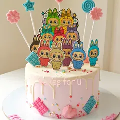 This adorable Labubu-themed cake was designed for a 10th birthday party. It features a crowd of colorful, edible Labubu character toppers on a pink drip cake, perfect for fans of the popular art toys.