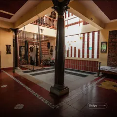 The central courtyard of the Padmaja Rao Residence is a modern interpretation of a traditional Indian architectural feature. It acts as the lungs of the home, allowing for natural light and ventilation while creating a tranquil, private space for the family. The use of classic elements like the swing and stone pillars brings a sense of heritage and calm.