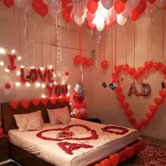 We love adding personal touches to your celebration. This romantic room makeover features custom initials inside a heart made of balloons, along with an "I Love You" message, hundreds of balloons, and rose petals for a deeply personal surprise.