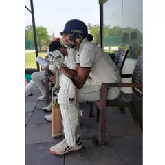 A moment of focus while waiting for my turn to bat. Mental preparation and concentration are just as important as physical practice.