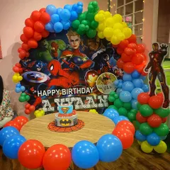 Assembling the mightiest heroes for an Avengers-themed birthday. The decor features a personalized backdrop with all the main characters and a life-sized Iron Man cutout.