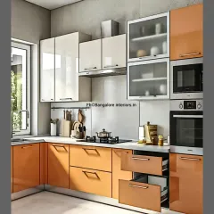 A vibrant L-shaped kitchen with glossy orange and white cabinets. This design shows how to use color effectively, with practical features like pull-out drawers and frosted glass cabinets.