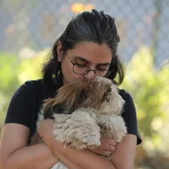 A guest sharing a tender moment with a fluffy friend during our dog party. These events are filled with love, laughter, and lots of cuddles.
