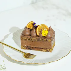 A slice of our orange and chocolate pastry, beautifully presented on a plate. A perfect single-serving treat for when you need a little indulgence.