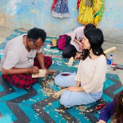 Teaching is a very important part of my work. Here, I am guiding a student during a wood carving workshop, showing her how to shape the puppet's head using traditional tools and techniques passed down through generations.