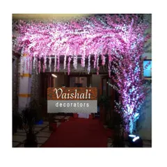 A beautiful entrance arch made entirely of illuminated pink blossoms. This creates a magical and romantic entryway for your guests, perfect for an evening reception.