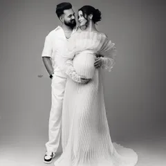 The same loving pose in timeless black and white. This edit really emphasizes the emotional connection and the beautiful textures of their outfits.