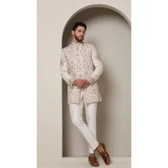 An ivory bandhgala jacket intricately detailed with blush peach and rose gold thread embroidery. The delicate jaal work and floral boota motifs create a look of timeless sophistication, perfect for a daytime wedding or elegant formal event.