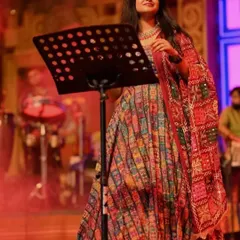 A vibrant, multi-colored lehenga worn for a festive performance. This look is perfect for a lively sangeet night or a Navratri celebration.