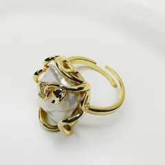 I love the organic shape of this baroque pearl ring, wrapped in a gold-plated chain. A true statement piece.