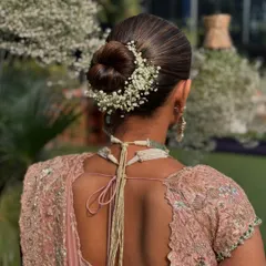 Simplicity and elegance are key for a classic bridal look. I created this neat, polished bun and encircled it with delicate baby's breath, or gypsophila, for a soft and romantic finish. This is a perfect hairstyle for an Anand Karaj or a daytime wedding ceremony.