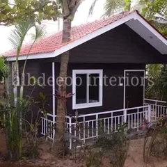 A classic prefab villa with a tiled roof and a small porch, perfect for a farmhouse setting. The design is simple, elegant, and blends well with the surrounding greenery.