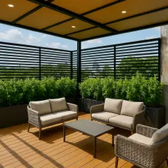 I designed this modern terrace in Gurugram to be a true outdoor living room. The combination of a wooden deck, comfortable wicker furniture, and a privacy screen of dense shrubs creates a chic, functional space for employees or residents to unwind.