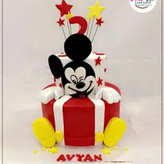 We brought the magic of Disney to this two-tiered birthday cake with a hand-sculpted Mickey Mouse figure. The classic red, white, and yellow colors make it a timeless choice for a joyful celebration.