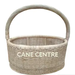 A classic, all-purpose round basket made from natural, light-colored cane. Its simple, tight weave and strong handle make it a durable choice for carrying items or for home display.