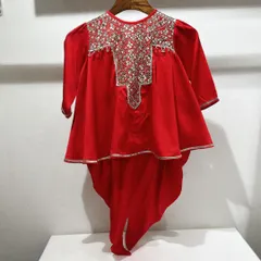 A detailed studio shot of the red peplum and tulip pants set. You can see the intricate silver embroidery on the yoke and the elegant high-low cut of the peplum top.
