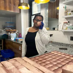 A happy moment in the studio, holding up a freshly cut bar of soap. The passion for what we do is poured into every single product.