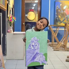 One of our youngest artists, Madhav, proudly shows off his completed ballpoint pen drawing. This imaginative piece features an owl and other animals, created with impressive detail for his age.