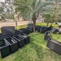 All the black FRP planters are unboxed and inspected on-site to ensure they are ready for installation.