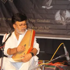 A guest artist performing on the swarmandal during our Gurupoornima celebration. We invite many respected musicians to share their art on this auspicious day.