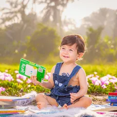 Capturing a quiet, candid moment during an outdoor toddler session. The soft natural light and beautiful field of flowers create a perfect, relaxed setting for your child's personality to shine.