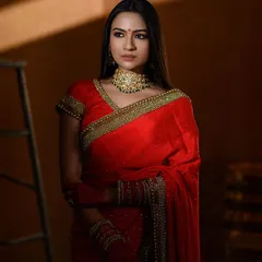 Inspired by the symbolism of the color red in Indian culture, this portrait uses shadows and light to create a powerful image. The model's pose is contemplative, framed by the rustic ladder in my studio.