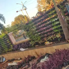 The vertical garden wall during installation. You can see the empty pots being filled to create a living wall.