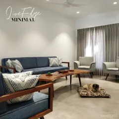 A minimal living room featuring our custom wooden-frame sofa and a live-edge coffee table. The clean lines and natural materials create a calm, airy space that even the dog approves of.