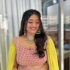 A beautiful smile completes this soft glam look. The makeup is focused on clean skin and shimmery pink eyeshadow, which makes her eyes pop while still looking natural and elegant.