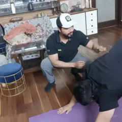 Demonstrating the next move and providing constant feedback during a one-on-one session at a client's home.