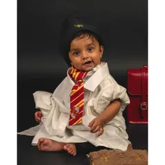 Another magical moment from the Harry Potter themed baby shoot. The costume and props add a playful narrative to this adorable infant portrait.
