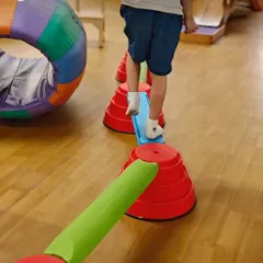 Occupational therapy can look like play, because that’s when children learn best. Here, a child navigates an obstacle course, building balance, coordination, and body awareness, which are foundational skills for focus and self-regulation in daily life.