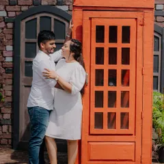 A fun and playful shot using a classic red telephone booth as a prop. This adds a pop of color and a touch of whimsy to the pre-wedding session.