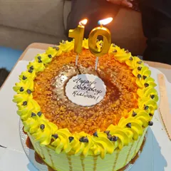 A classic butterscotch cake with homemade caramel sauce and crunchy nuts, ready for a 10th birthday celebration.