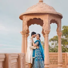 A moment of regal romance from a pre-wedding shoot. I styled the couple in coordinated traditional outfits, with the bride in a striking blue lehenga and the groom in a classic ivory sherwani, creating a timeless look against the beautiful Indian architecture.
