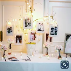 This elegant photo tree is a unique centerpiece for an anniversary or engagement party. I arrange your framed pictures on branches wrapped in fairy lights, creating a beautiful and personal focal point on a welcome table.