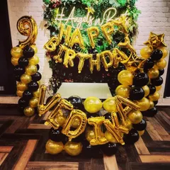 A unique backdrop combining a lush green wall with black and gold balloons. I can spell out any name or message with foil balloons to personalize the decoration for your birthday party.