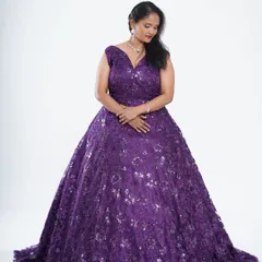 This purple ball gown is covered in delicate floral sequins, creating a beautiful, shimmering effect. It's a perfect choice for anyone wanting to feel like royalty at their event.