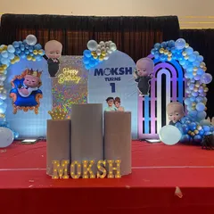 A grand Boss Baby stage decoration for a first birthday. I used multiple backdrops, a shimmer wall, character cutouts, and marquee letters spelling the name.