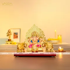 A 24K gold-plated Ganesha idol, elegantly seated with two matching elephant statues. This divine set is perfect for a home altar or as a prestigious gift for a housewarming or new beginning.
